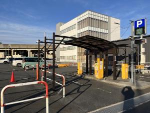 a parking lot with a bus stop at APA Hotel Tottori Ekimae Minami in Tottori
