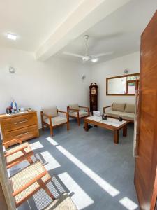 a living room with a couch and a table at THE DOCTORS VILLA in Ragama
