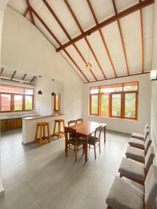 a kitchen and dining room with a table and chairs at THE DOCTORS VILLA in Ragama