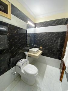 a bathroom with a toilet and a sink at Orbit Residency F-7 in Islamabad
