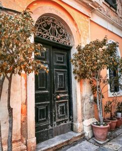 a black door on the side of a building at ''Dei Vecchi'' apartment in Kerkyra in Corfu Town