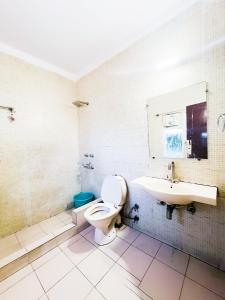 a bathroom with a toilet and a sink at Red House B&B - South Ex Near AIMS in New Delhi