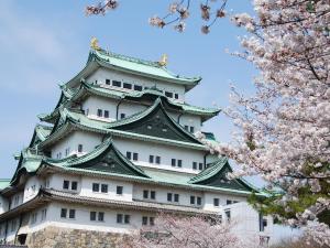 a japanese castle withakura trees in front of it at Nagoya Creston Hotel in Nagoya