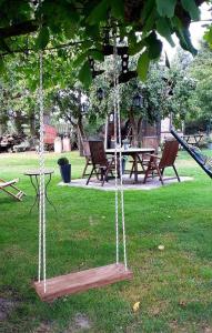 a swing set in a park with a picnic table at Ferienwohnung am Papensee in Hohen Sprenz