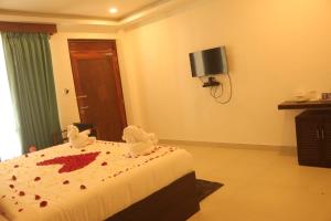 a hotel room with a bed with blood on it at Hotel Havelock Gateway in Havelock Island