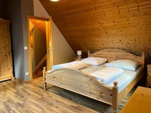 two beds in a room with a wooden ceiling at Ferienhaus 32 in Kinding