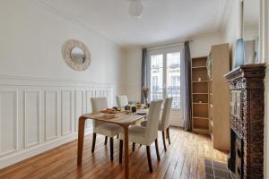 a dining room with a table and chairs at Lovely & authentic Flat - Parc des Expos - Paris 15 in Paris