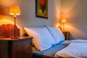 a bedroom with a bed with a pillow and a lamp at Chalupa Novákova vyhlídka in Ždírec +15 photos