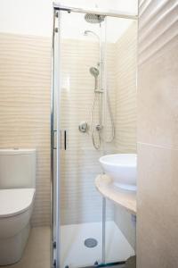 a bathroom with a shower and a toilet and a sink at Casa ORCHIDEA D'ORO in Siracusa +25 photos