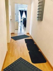 a hallway with mats on the floor of a room at Haus Volksbank FV in Binz