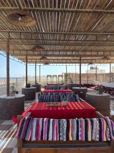 a group of tables with red table cloth at La Casa Budget in Marsa Alam City