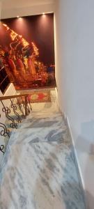een hal met een marmeren vloer en een schilderij aan de muur bij The Kashi Inn. A 7 bedroom holiday home. Near Assi Ghat. in Upal