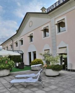 a hotel with two chairs in front of a building at Best Western Hotel Solaf in Medolago