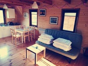 a living room with a couch and a table with chairs at Przystań - Aktywna strona Iłży in Iłża +23 photos