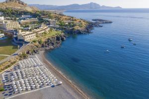 an aerial view of a beach with boats in the water at Lindos Royal Resort in Líndos