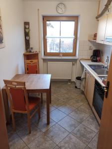 a kitchen with a table and a table and a window at Im Ruhepol in Petting