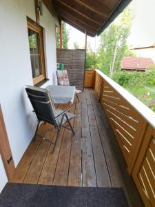 a deck with a table and a chair on it at Im Ruhepol in Petting