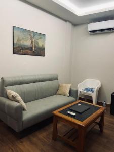a living room with a couch and a coffee table at Sunset Homes Imphal in Imphal