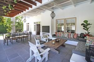 a living room with a couch and a table at Le Bas De Laine in Franschhoek