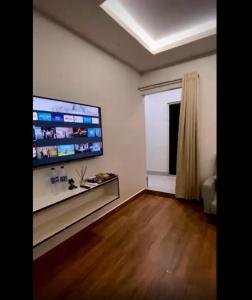 a living room with a large flat screen tv on the wall at Sunset Homes Imphal in Imphal