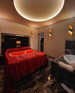 a bedroom with a bed and a bath tub at Black Suite Hydro in Montecatini Terme