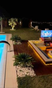 a view of a backyard with a pool at night at Villa safkan in Silivri