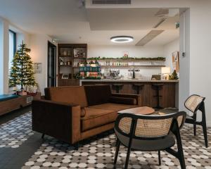a living room with a couch and a christmas tree at Beau M Paris in Paris