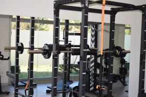 a gym with a squat rack with weights at Parkhotel Montigeto in Passignano sul Trasimeno