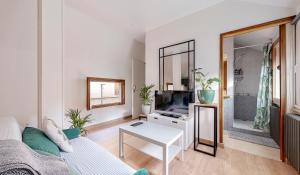 a living room with a couch and a tv at Huge House 210sqm 19 people Private Outdoor 2 Parking Top Location in Saint-Ouen