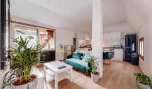 a living room with a couch and some plants at Huge House 210sqm 19 people Private Outdoor 2 Parking Top Location in Saint-Ouen