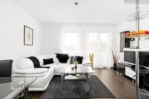 a white living room with a white couch and a table at BNB New Beautiful Apartment in the Center of Ostrava with option Garage Parking in Moravská Ostrava