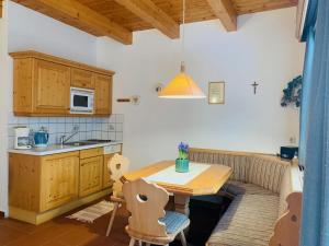 a kitchen with a wooden table and a couch at Ferienhaus Sükar in Bad Kleinkirchheim