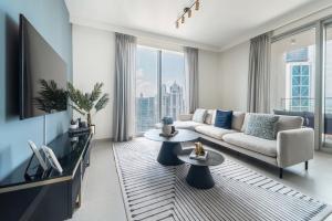 a living room with a couch and a tv at Frank Porter - Forte Tower 1 in Dubai