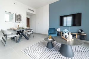 a living room with a table and a tv at Frank Porter - Forte Tower 1 in Dubai