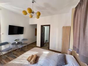 a bedroom with a bed and a table and a tv at Navial 1 in Gabrovo