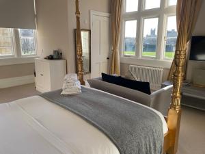 um quarto com uma cama, um sofá e janelas em Number 17 Bath em Bath