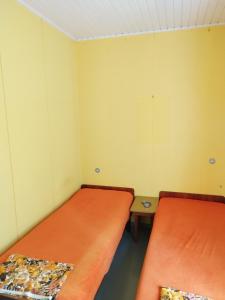 Cette chambre comprend 2 lits et une table. dans l'établissement Topsala MidIsland, à Houtskari