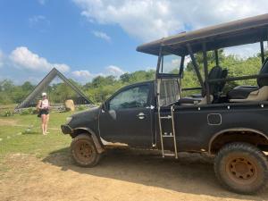 a black jeep parked in front of a tent at Basecamp - Yala in Yala