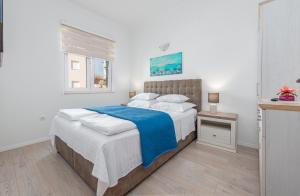 a bedroom with a bed with a blue blanket at Luxury Villa Agape Palm Beach Tennisplatz in Privlaka +161 photos