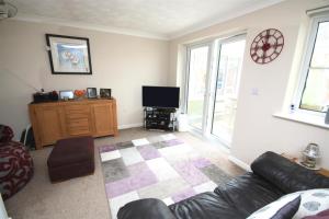 a living room with a couch and a tv at No1 Apartment House in Stainforth