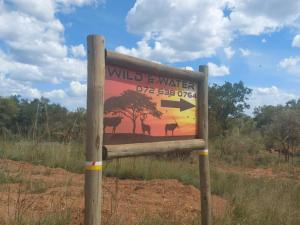 a sign in the middle of a field at Wild and Water Dinokeng in Dinokeng Game Reserve