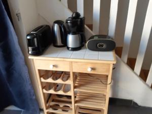 a small table with a coffee maker on top of it at nice little cottage F2 class and 3* in Vars