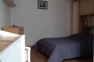 a bedroom with a bed and a dresser in it at nice little cottage F2 class and 3* in Vars
