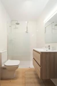 y baño con aseo, lavabo y ducha. en Casa Cauma Apartamento en Albarracín