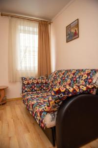 a living room with a couch with a colorful blanket at Asian Mountains in Bishkek