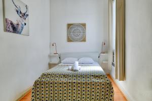 a bedroom with a bed with a gold and white blanket at NOCNOC - Le Minot in Marseille