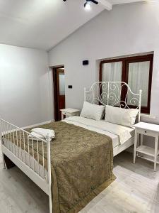 1 dormitorio con 1 cama blanca y 2 mesas en Tiny 1, en Estambul