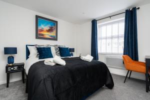 a bedroom with a large bed and a window at Brighton Apt - 2 Bedroom Free Wi-Fi & Parking in Wallasey