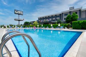 a large swimming pool with chairs and a hotel at Vela Verde Hotel & SPA in Yalova