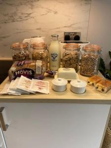 a shelf with jars of nuts and other food items at The Burrow Devon in Longdown